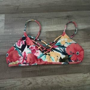 Bikinis top with floral designs and crisscross on the front. Comes with padding.